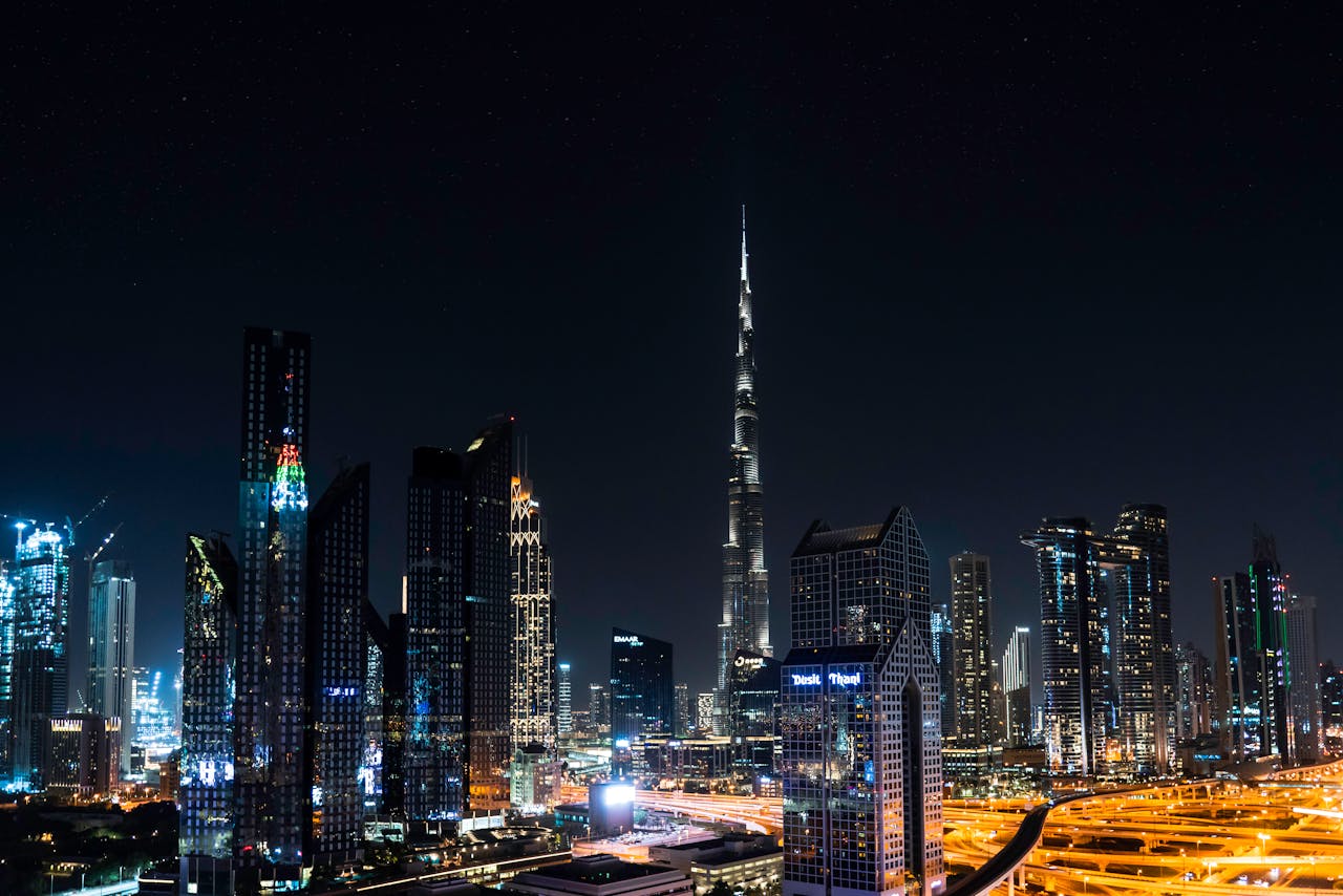 Stunning nighttime view of Dubai's skyline with the iconic Burj Khalifa illuminated under a starry sky.