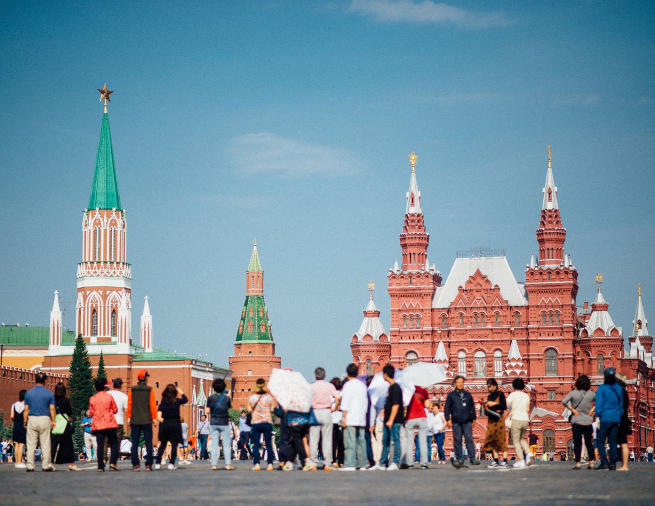 Tourists gathered at Red Square with views of the Kremlin and State Historical Museum in Moscow.